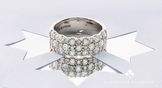 This ring is a ten-tabler! (You can see it 10 tables away.)
Thirty-three VS2, H-I Canadian Maple Leaf Diamonds™ totalling 1.5ctw. WOW! Looks even more brilliant in person.
(Also available in 2 and single row.)